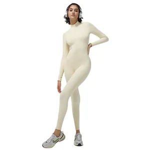 Cream ribbed long sleeve yoga jumpsuit with front zipper and slim fit athletic silhouette