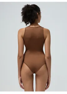 Close-up of the ribbed fabric texture and back cut of this brown seamless yoga bodysuit