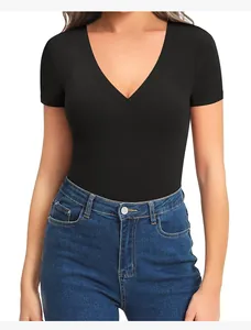 Front view of slim fit black V-neck short sleeve yoga bodysuit styled with jeans