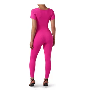 Back view of hot pink ribbed seamless yoga jumpsuit with short sleeves and long pants