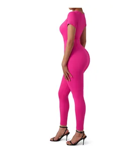 Close-up of ribbed texture and stretchy fabric on magenta short sleeve yoga jumpsuit