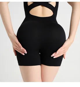 Detailed back view of black ribbed workout bodysuit featuring cross strap open back design