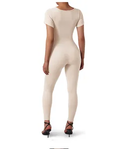 Close-up back view of beige ribbed knit jumpsuit showing fit and scoop neck detail