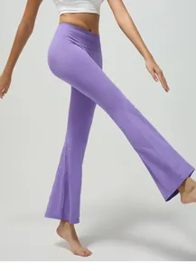 Detailed view of high-waist purple flare yoga pants with ribbed texture and loose fit