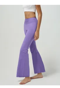 Detail of high-waist lavender flared yoga pants showing butt-lifting effect and stretch fabric