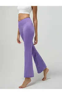 Detail shot of purple high-waisted flare yoga pants with elastic peach hip lifting design