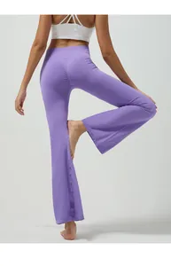 Close-up of high-waisted purple flared yoga pants featuring peach butt lift seam detail