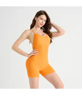 Detail of orange yoga bodysuit with cross straps and ribbed seamless fabric for support