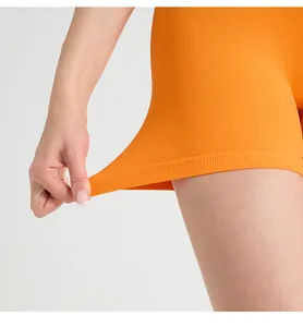 Detail showing highly elastic orange ribbed fabric with a hand stretching the athletic material
