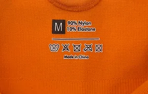 Close-up of knit fabric label showing 90% nylon and 10% elastane material composition