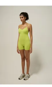 Close-up of fluorescent green yoga bodysuit with thin straps and smooth elastic fabric