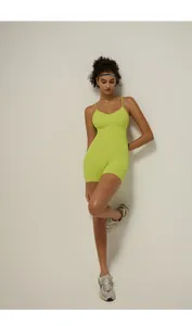 Close-up of vibrant neon green yoga bodysuit with thin straps and sleek v-neck design