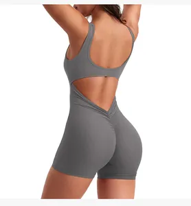 Macro view of dark grey yoga romper featuring an open back V-cut and ruched booty detail
