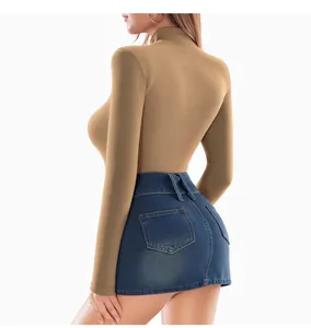 Detail shot of khaki turtleneck bodysuit and dark blue high-waist denim skirt