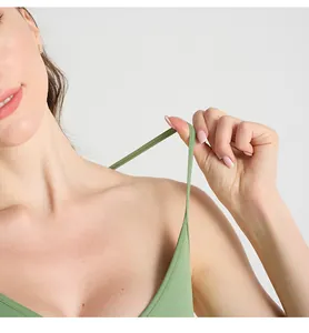 Close-up of grass green yoga bodysuit showing high elastic straps and ribbed fabric texture