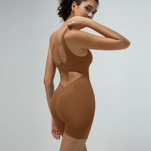 Detail of caramel backless yoga bodysuit showing hollow-out cut and ribbed fabric