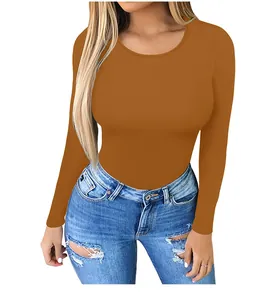 Detail of caramel brown long sleeve crewneck slim fit bodysuit in high stretch fabric