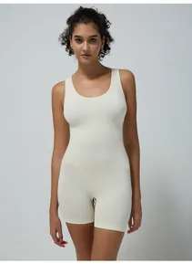 Close-up of seamless ivory lycra fabric on a slimming sleeveless yoga bodysuit