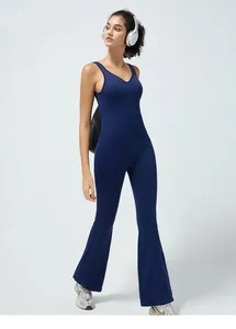 Detail view of navy blue one-piece yoga jumpsuit with flare legs and open back design