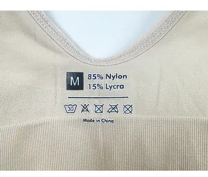 Detail of printed care label showing size M and 85% Nylon 15% Lycra fabric blend