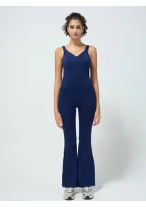 Detail of dark blue sleeveless yoga jumpsuit featuring V-neck and split flare leg pants