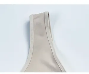 Close-up of seamless beige shapewear bodysuit straps with durable double-stitched seams