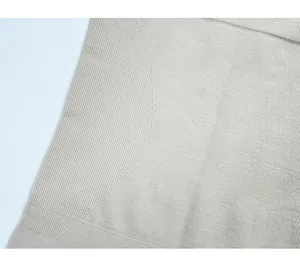 Macro detail of high-elasticity vertical rib knit fabric on seamless beige bodysuit