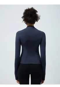 Detailed back view of seamless navy blue yoga jacket showing breathable knitted texture