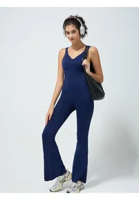 Detail of slim fit yoga bodysuit with cross back design and flare leg pants