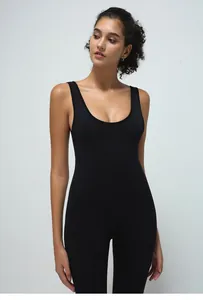 Detail of black sleeveless flared jumpsuit with bodycon fit for yoga and fitness