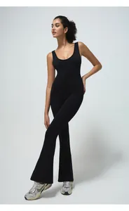 Detail of black seamless flared jumpsuit showing the tight fit and elastic ribbed fabric
