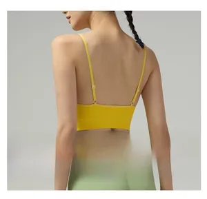 Detail of yellow sports bra with thin straps and supportive ribbed hem for yoga