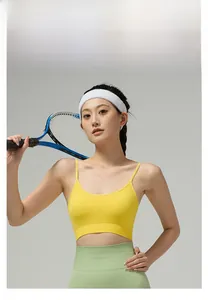 Detail of lemon yellow seamless sports bra with thin straps and high-waist green yoga leggings