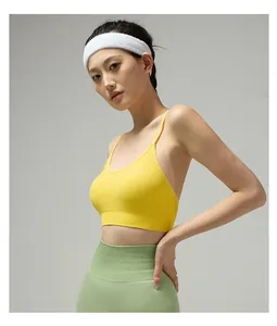 Detail view of yellow sports bra with thin straps and high-waist green leggings set