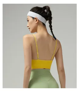 Detailed back view of yellow sports bra with adjustable thin straps and ribbed hem