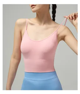 Detail view of pink yoga bra with cross-back straps and wide ribbed hem support