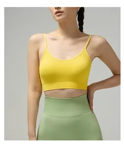 Detail of thin straps and ribbed hem on bright yellow seamless sports yoga bra