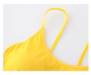Close-up of vibrant yellow sports bra showing reinforced stitching and premium fabric texture