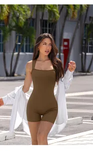 Close-up of brown ribbed yoga romper with square neck and white shirt layering