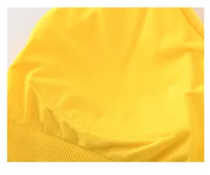 Detail shot of bright yellow sports bra with ribbed hem and high-quality curved stitching