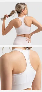 Detailed view of pink high-impact yoga bra showing cross back design and ribbed texture