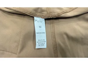 Detail view of workout leggings wash label showing size M and high quality fabric composition
