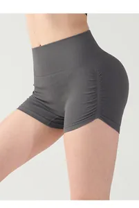 Close-up of high-waisted gray scrunch yoga shorts showing ribbed texture and lifting effect