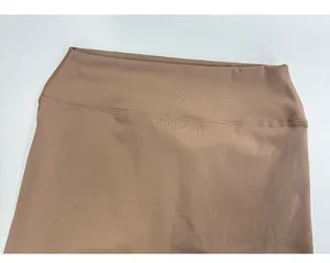Detail of high-waisted yoga leggings showing cocoa brown fabric texture and flatlock seams