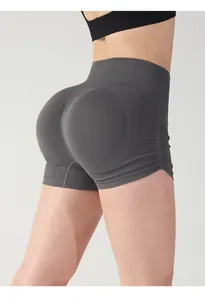 Detail view of seamless dark gray high waisted scrunch butt yoga shorts with ribbed texture