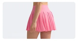 Close-up of pink high-waisted pleated tennis skort showing minimalist design and fabric