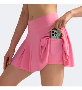Detail of pink pleated athletic skort showing hidden side pocket with smartphone storage