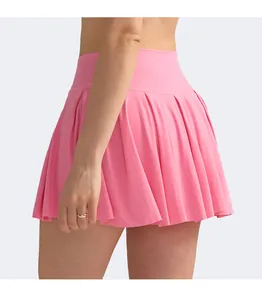 Detail of high-waist pleated tennis skort in pink moisture-wicking stretch fabric