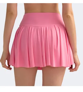 Rear view of pink high-waisted pleated tennis skirt showing stretch fabric and fit