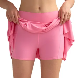 High-waisted pleated tennis skort in pink with inner shorts and functional side pockets